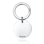 Round silver keyring with hallmarks on a white background