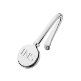A polished silver napkin hook with a circular disc end engraved with the initials 'INS', shown on a plain white background.