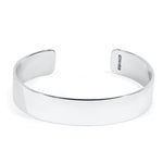 Silver cuff bracelet with a polished texture on a white background