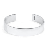 Silver cuff bracelet with a polished texture on a white background