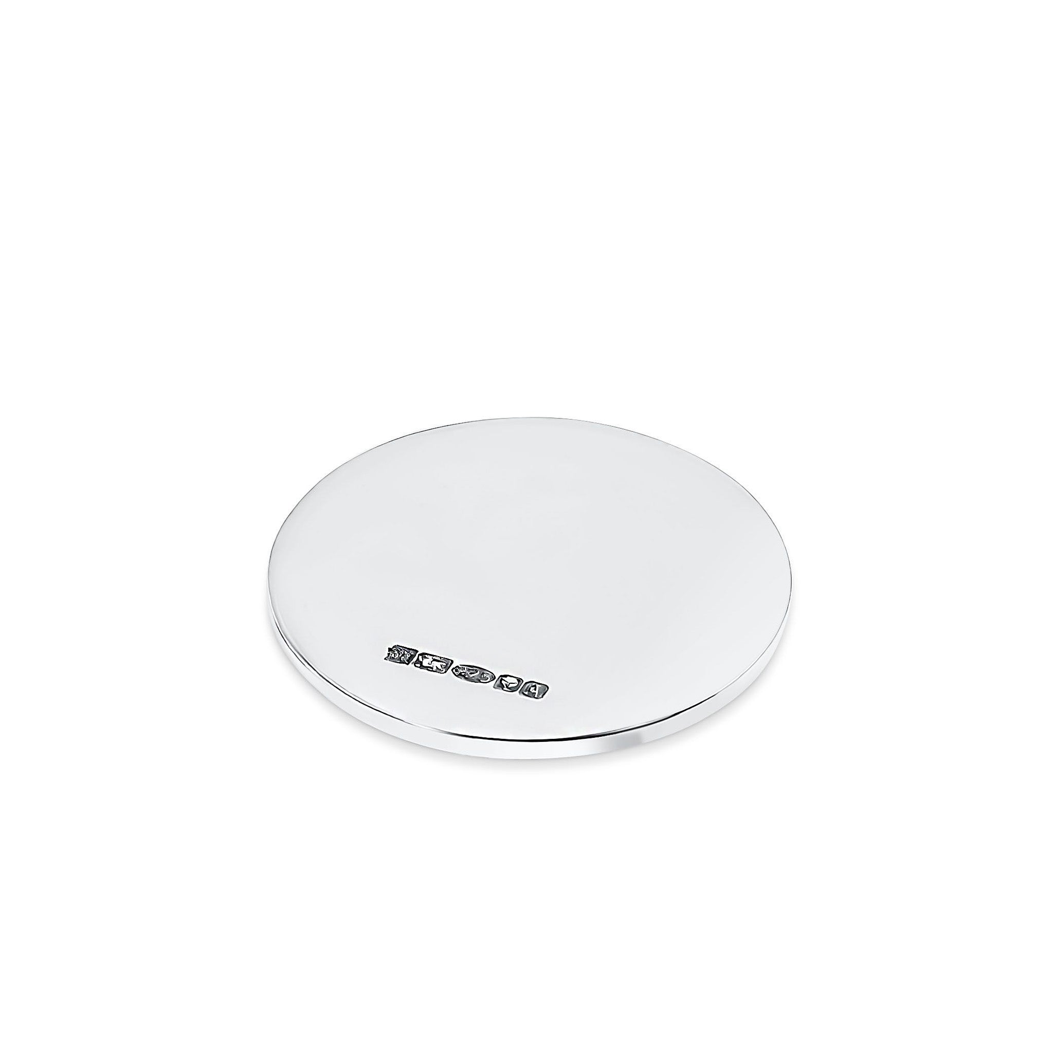 Sterling silver circular golf ball marker on a white background.