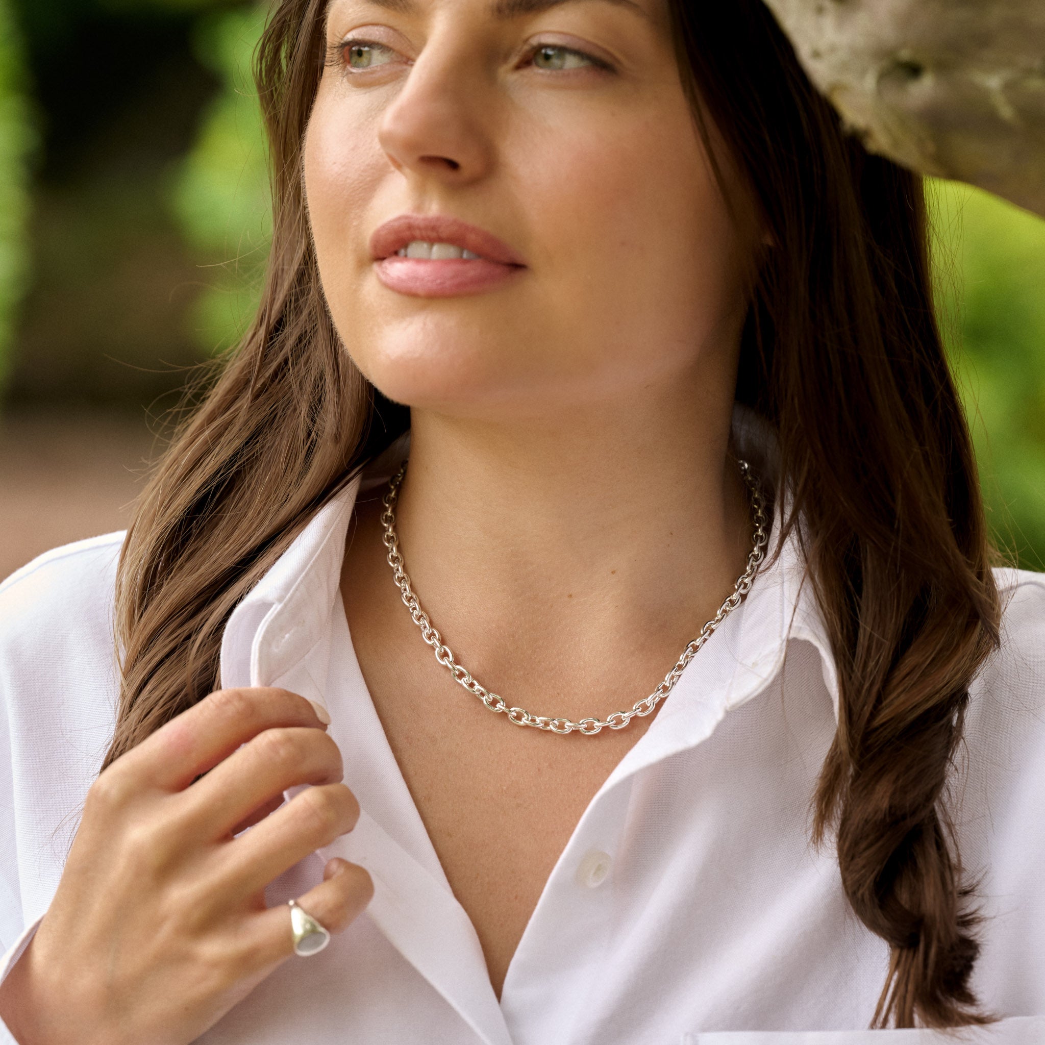 Woman wearing a silver necklace outdoors