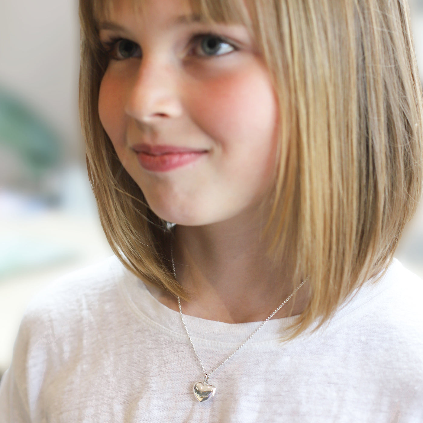 Child wearing heart locket necklace