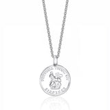 Silver sixpence pendant necklace on a white background
