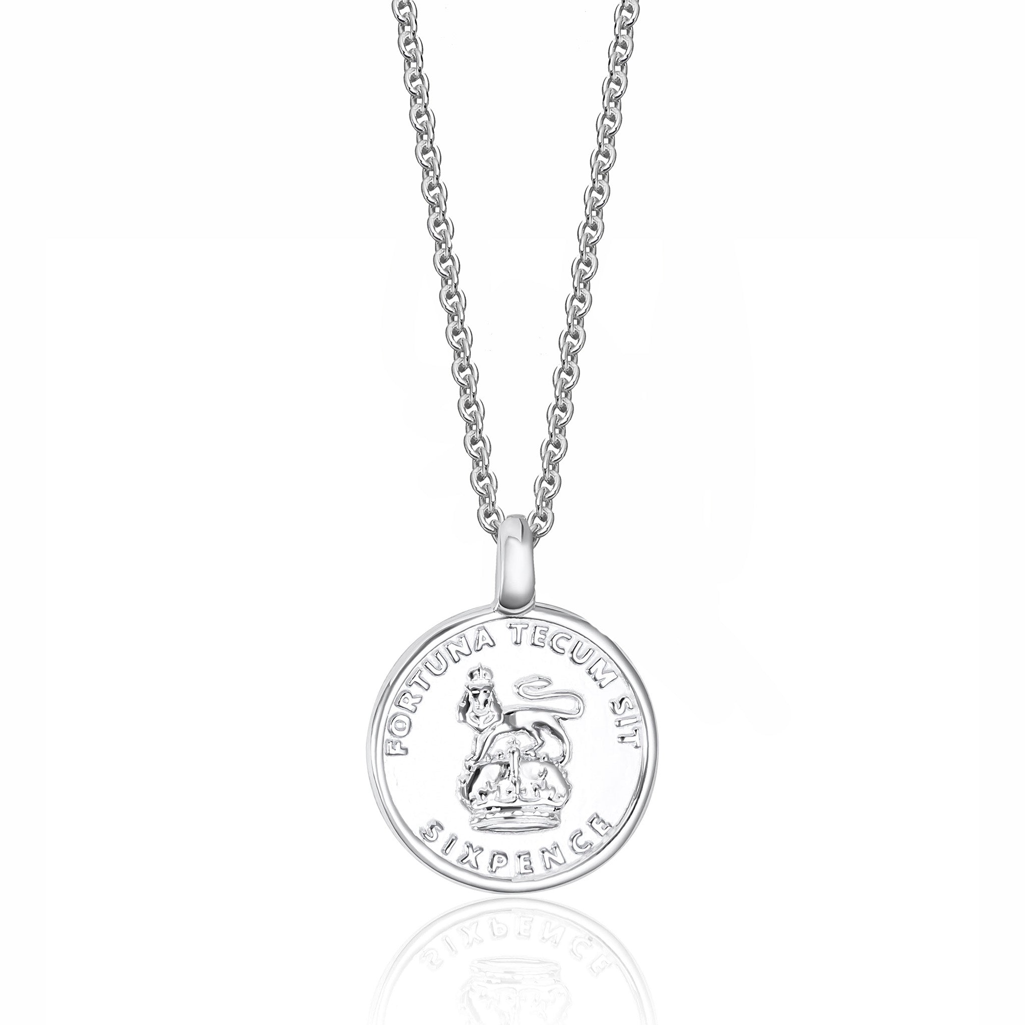 Silver sixpence pendant necklace on a white background