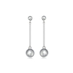 Pair of silver earrings with spherical  ball ends on a white background