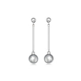 Pair of silver earrings with spherical  ball ends on a white background
