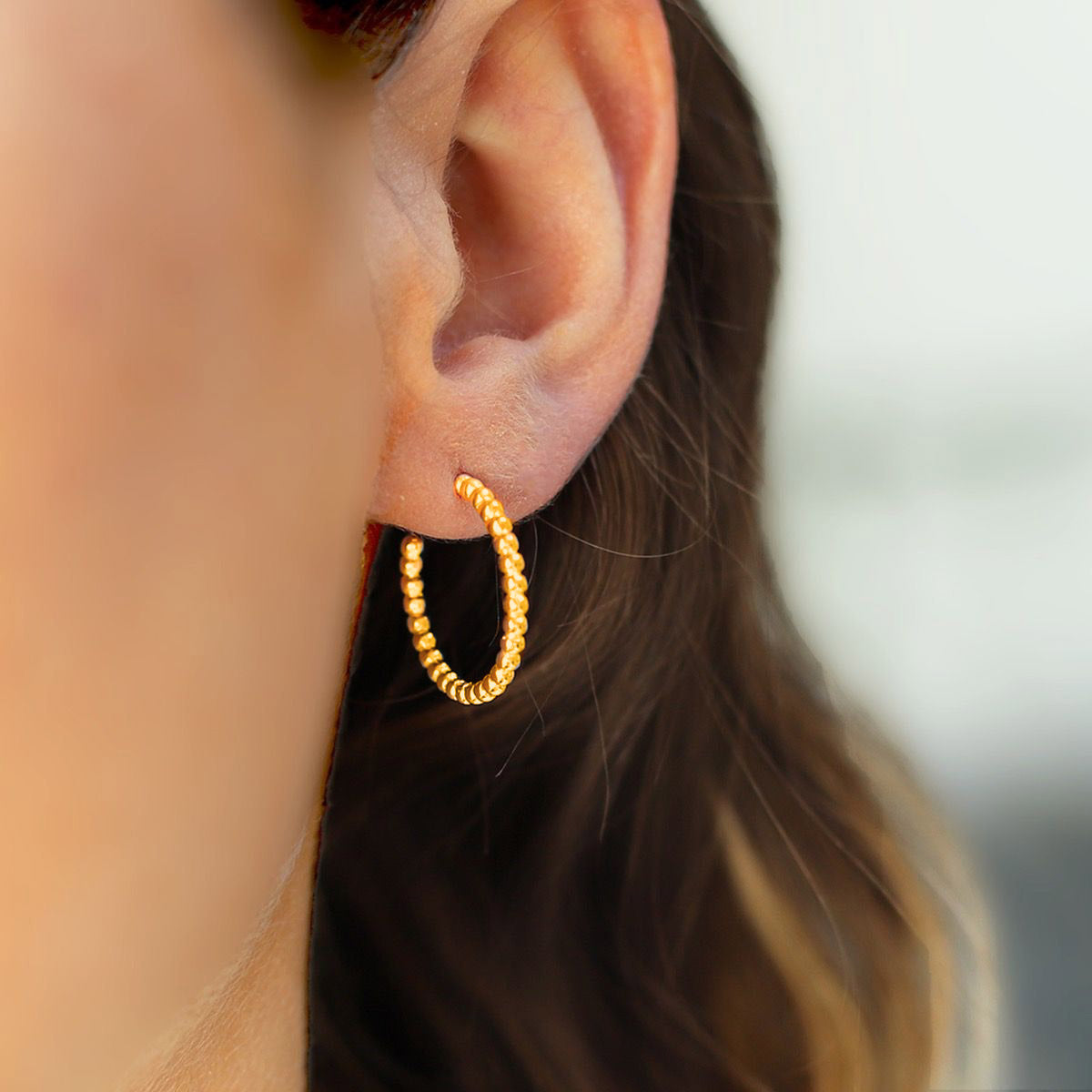 Slim gold and silver ball hoop earring 